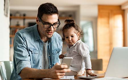 man-and-toddler-looking-at-phone