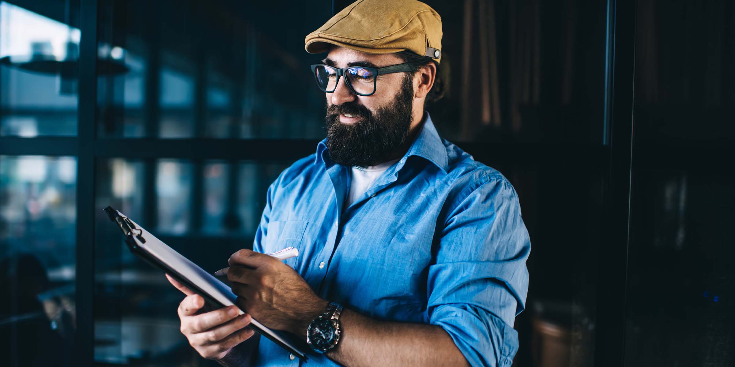 A person reviews a business report with focused attention, representing the financial clarity and operational control supported by BankNewport's business banking services, business checking account products, and dedicated business financial management tools available to Rhode Island business owners and managers.